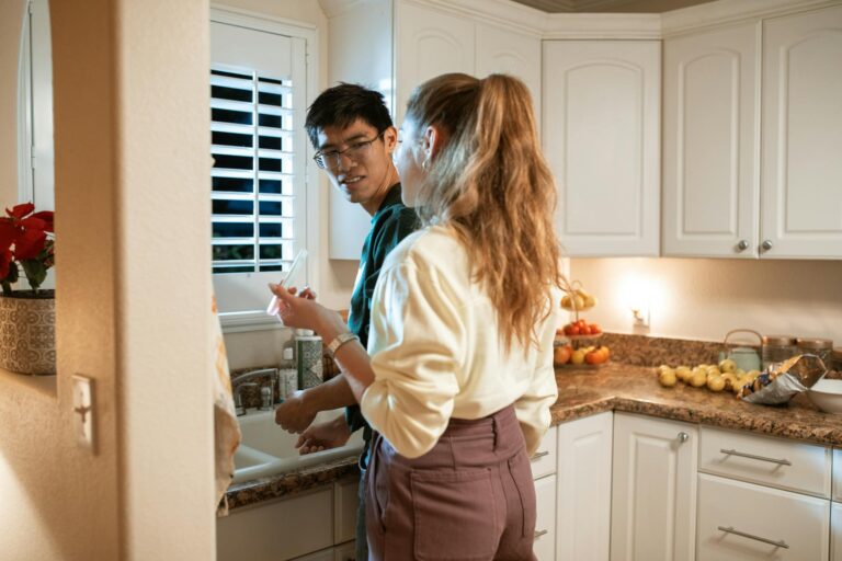 Happy couple preparing food in their contemporary kitchen, enjoying a relaxed evening together.